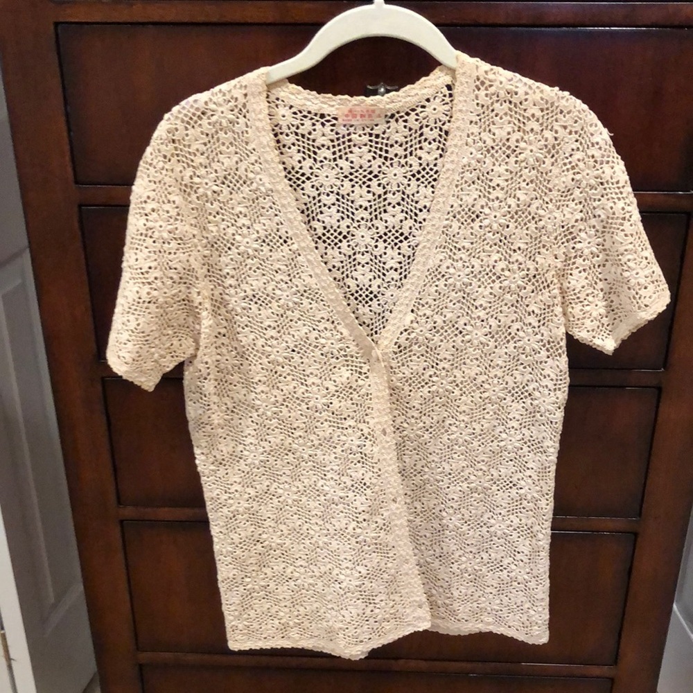 Beige crocheted short sleeve jacket sweater. Size Large with extra button inside